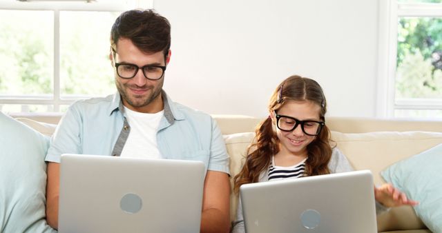 Father and Daughter Using Laptops Together at Home - Download Free Stock Images Pikwizard.com