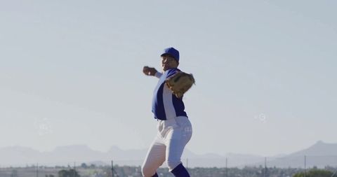 Female Baseball Pitcher Winding Arm in Outdoor Game