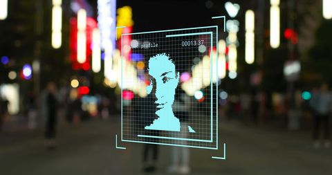 Digital facial recognition technology in urban environment at night