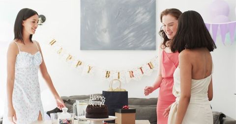 Friends Planning Birthday Celebration in Bright Dining Room