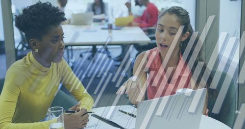 Diverse business women analyzing financial data