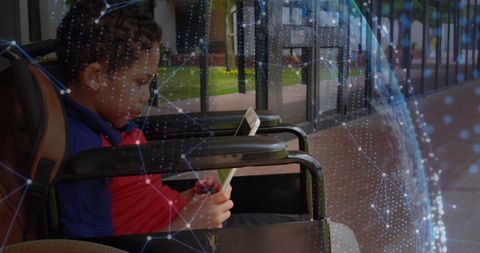 Young african american boy in wheelchair using digital tablet technology