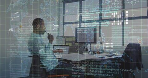 Tech engineer working with code and maps on dual monitors