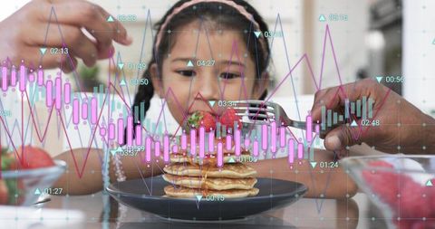 Girl reaching for strawberry on pancakes with parent hands and digital analytics overlay