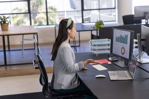 Professional Modern Office with Charts on Screen
