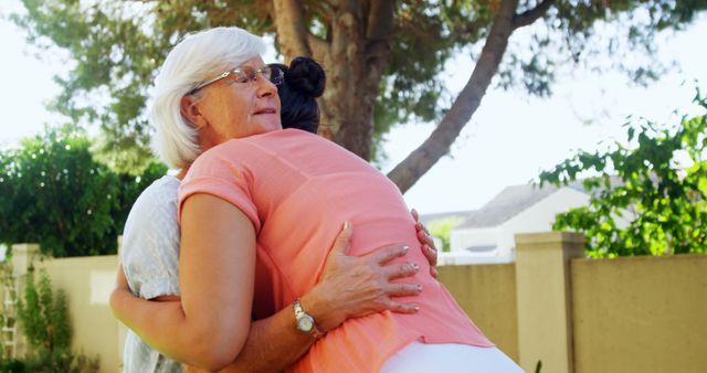 Senior Woman and Adult Daughter Embracing in Garden - Download Free Stock Images Pikwizard.com