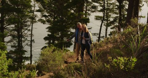 Senior Couple Hiking Through Scenic Coastal Forest