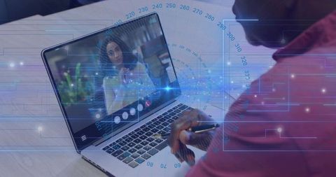 Senior professional watching virtual meeting on laptop with digital HUD overlay and pen