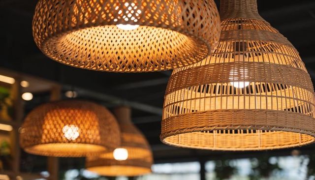 Glowing rattan pendant lamps casting warm amber light over rustic cafe interior