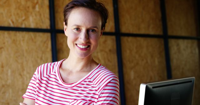 Confident Woman Smiling in Modern Office with Computer Monitor - Download Free Stock Images Pikwizard.com