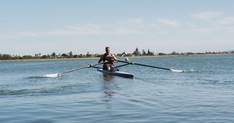 Senior Man Rowing on Serene River during Clear Day - Download Free Stock Images Pikwizard.com