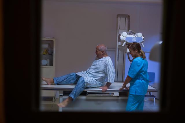 Patient lying on x-ray machine at hospital