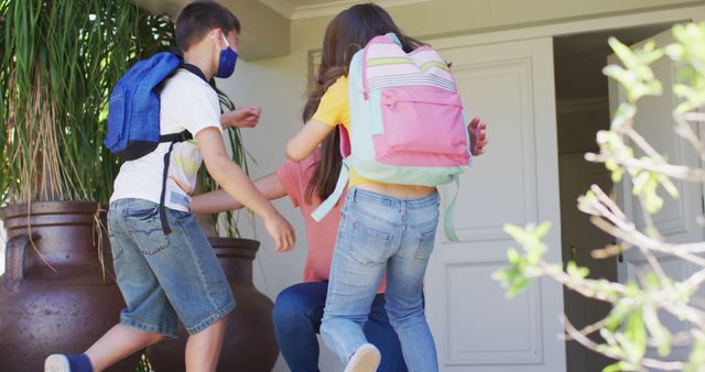 Mother Hugging Excited Children Coming Home from School - Download Free Stock Images Pikwizard.com