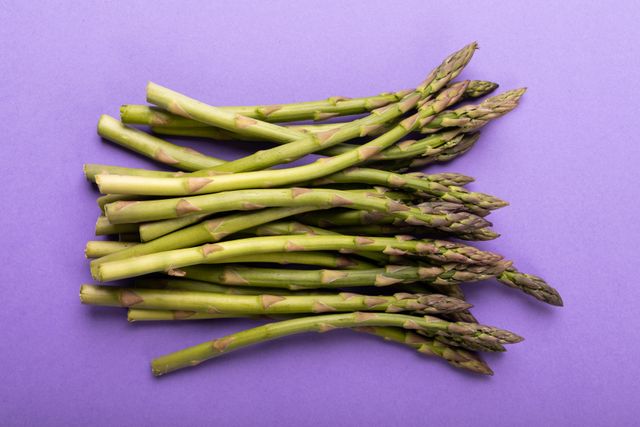Directly above shot of asparagus on purple background, copy space. unaltered, food, healthy eating, studio shot and organic.