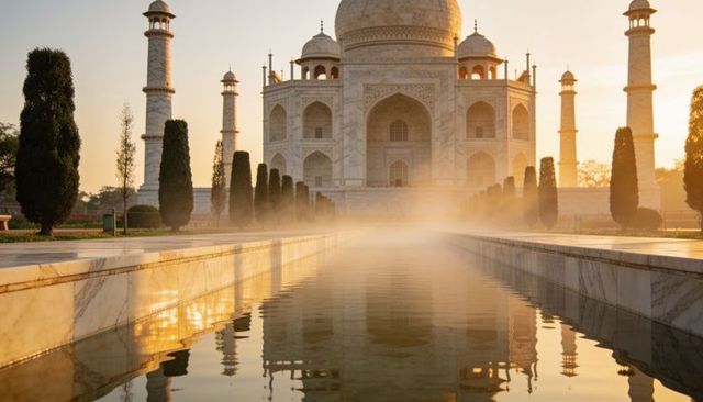 Taj mahal at sunrise glowing white marble reflection over pool with mist, mughal architecture