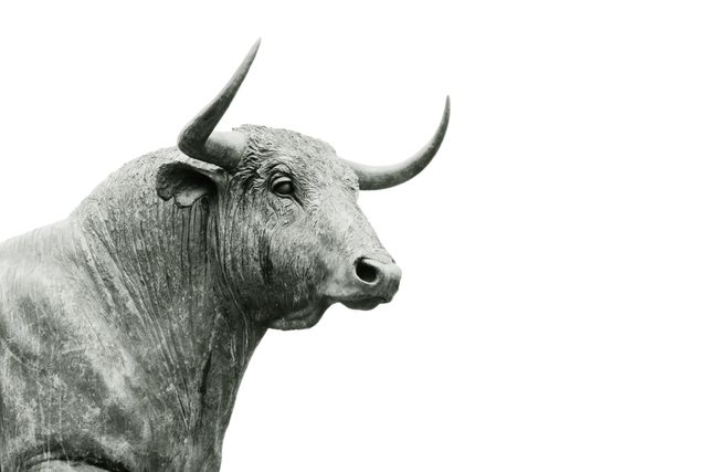 Depicts a majestic bull sculpture with detailed textures and dominant horns set against a plain white background. Ideal for use in themes related to strength, art, agriculture, and animal symbolism. Suitable for websites, advertisements, articles, and educational materials highlighting the cultural significance of bulls.