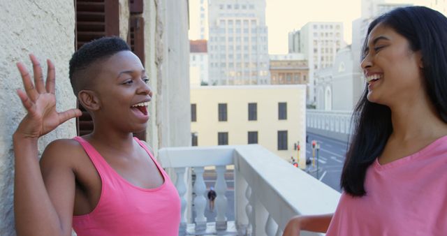 Cheerful Friends Enjoying Conversation on Balcony in Urban Setting - Download Free Stock Images Pikwizard.com