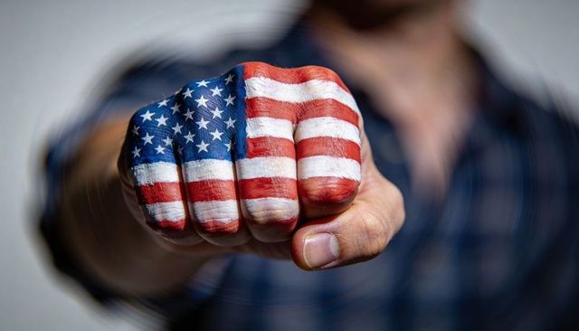 Fist painted with american flag pointing forward expressing patriotism and strength