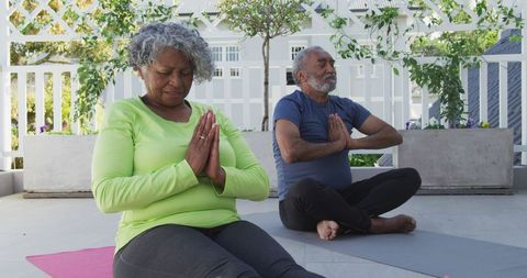 Senior Couple Meditating on Yoga Mats Outdoors