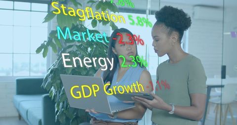 Diverse businesswomen analyzing financial growth trends in modern office