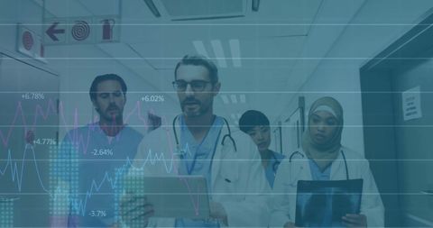 Doctors analyzing data with financial overlay in hospital