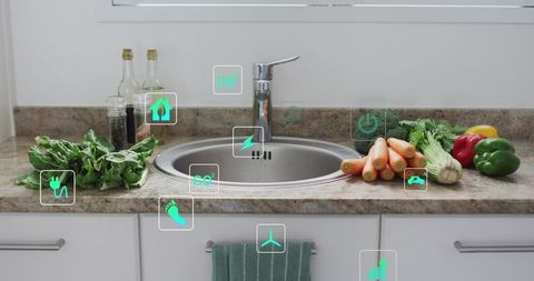 Modern stainless sink with fresh vegetables and smart sustainability icons on countertop