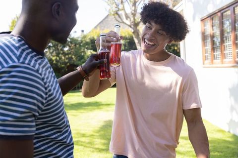 Diverse Friends Toasting with Refreshing Red Drinks Outdoors