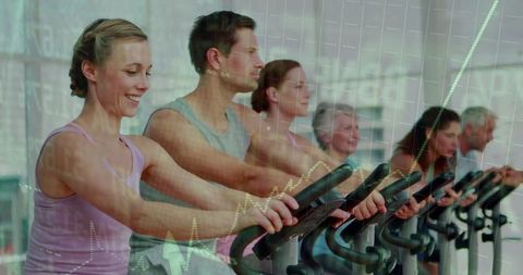 Group Exercise on Stationary Bikes in Fitness Studio Reflection