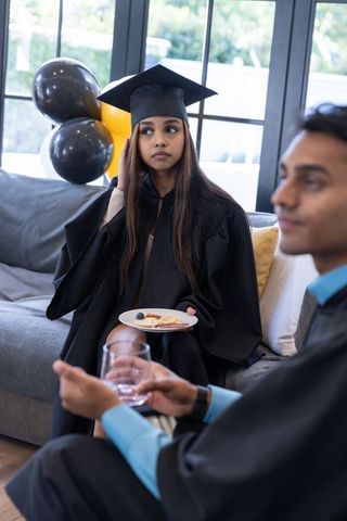 South Asian Graduates Celebrating with Snacks in Living Room
