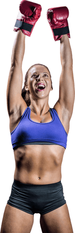 Triumphant woman boxer celebrating victory with raising arms