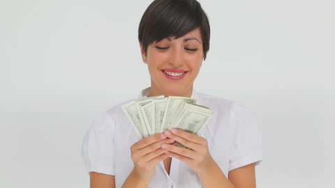 Businesswoman Counting Stack of Banknotes With Delighted Expression