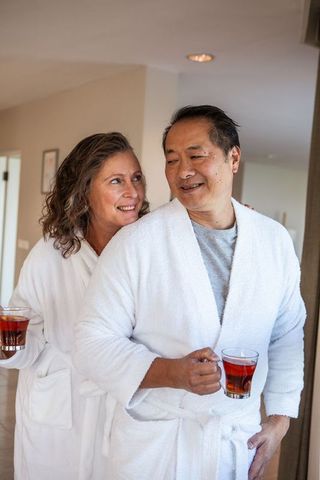 Smiling Couple Enjoying Hot Tea in Cozy Home Moments