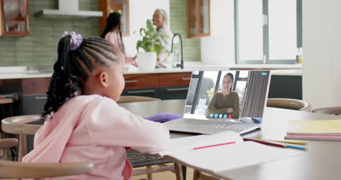 Girl engaged in a video call with a family member over the Christmas holiday. Suitable for illustrating family communication, modern technology connecting relatives, or child participation in digital interactions during festive celebrations.