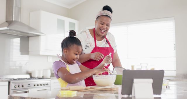 Mother and daughter baking together, joyful kitchen moment - Download Free Stock Images Pikwizard.com