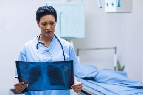 Doctor analyzing chest x-ray in medical exam room