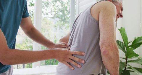 Senior Man Receiving Physiotherapy for Back Pain