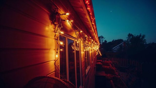 Warm String Lights on House at Twilight