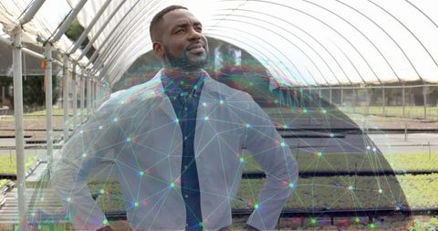 Confident Researcher in Greenhouse with Futuristic Overlay