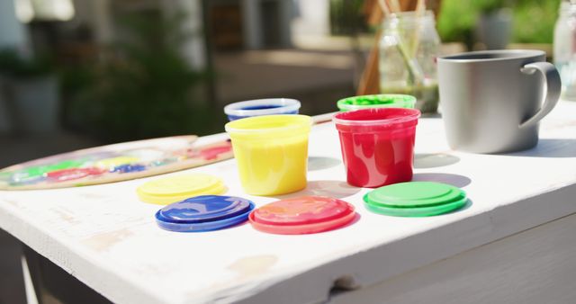 Colorful Paint Pots on Outdoor Table - Download Free Stock Images Pikwizard.com