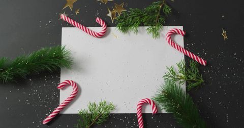 Festive christmas border with candy canes and greenery