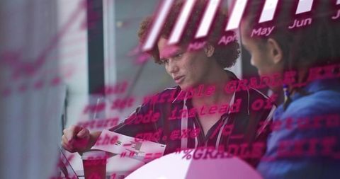 Collaborating on data analysis with magenta code overlay, charts, laptop and coffee