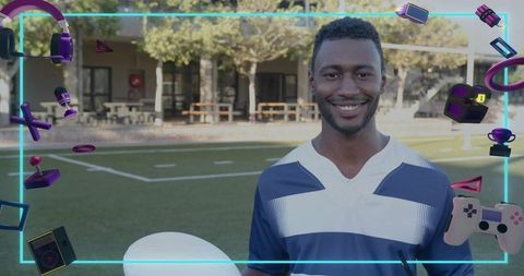 Smiling athlete holding white ball on turf framed by neon gaming icons and controller