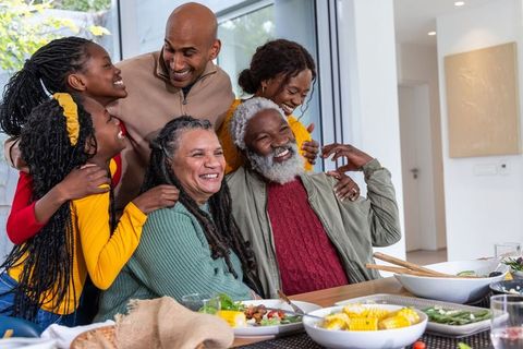 Multigenerational family sharing joyful meal at sunlit modern dining table