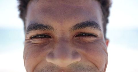 Close-Up of a Smiling Man by Beach, Joyful Emotion