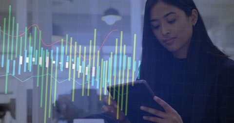 Businesswoman analyzing digital financial graphs on tablet