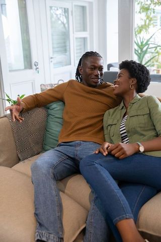 African American Couple Relaxing on Sofa in Cozy Living Room
