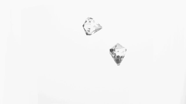 Two crystal-clear diamonds are falling in slow motion against a white background. Perfect for advertisements showcasing jewelry, gemstones, or luxury brands. The minimalist and elegant visuals can be used for promotional materials, presentations, or digital marketing campaigns focusing on luxury and elegance.