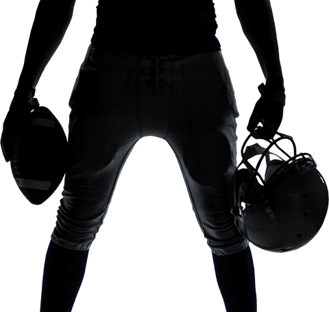Silhouette of american football player holding ball and helmet