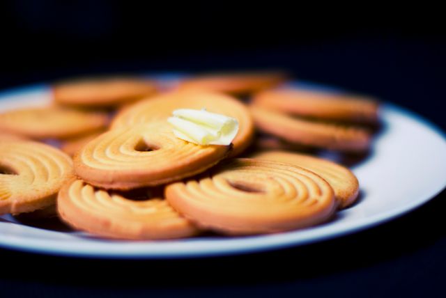 Close-up of Butter Cookies on Plate with Pat of Butter - Download Free Stock Photos Pikwizard.com