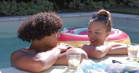 Relaxed Couple Chatting by Swimming Pool on Sunny Day
